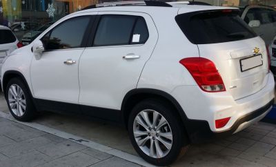 Rear side view of white SUV with alloy wheels and tinted windows