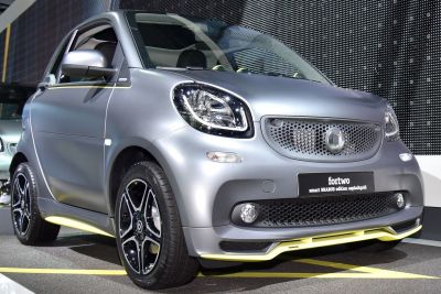 Front and side view of compact car with distinctive grille and sporty wheels