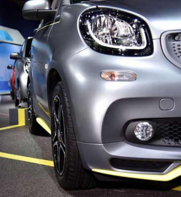 Close-up of car front with LED headlight, fog light, and alloy wheel