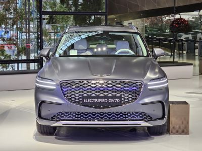Electrified SUV front view with LED headlights and patterned grille