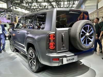 Rear side view of SUV with mounted spare wheel and dual taillights