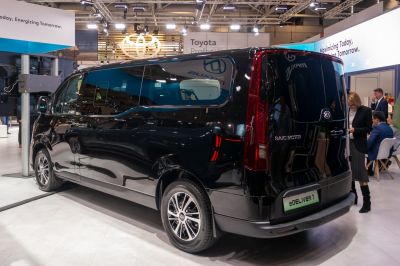 Rear and side view of an electric van with sleek black finish and distinctive taillights