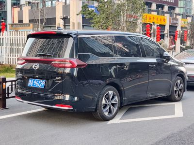 Rear side view of modern MPV with sleek tail lights and tinted windows