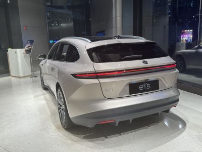 Rear view of electric station wagon with LED light bar and panoramic roof.