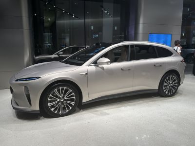 Streamlined electric touring sedan with aerodynamic curves and multi-spoke alloy wheels