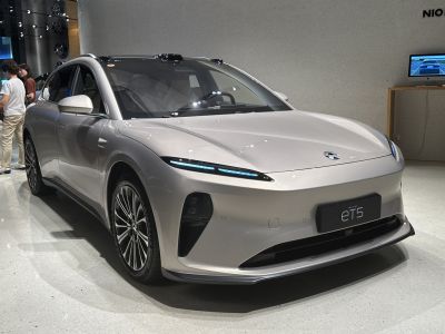 Electric sedan with slim LED headlights and multi-spoke wheels