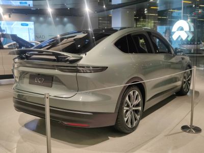 Rear view of electric sedan with sleek spoiler and taillights
