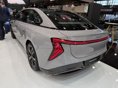 Sleek modern sedan rear with angular LED tail lights and continuous light bar
