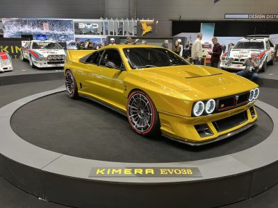 Yellow sports coupe with quad halo headlights and aerodynamic body