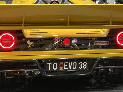 Rear view with circular LED taillights and rear diffuser in yellow body