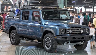 Double cab pickup truck with off-road tires and roof rack