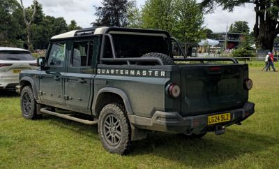 Rugged pickup truck with rear cargo bed and off-road tires