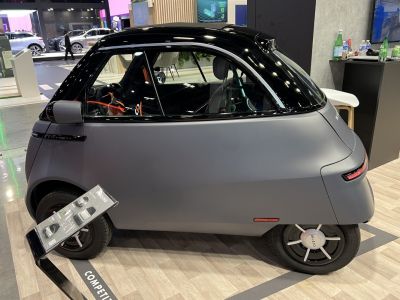 Compact microcar with single door and smooth, futuristic design
