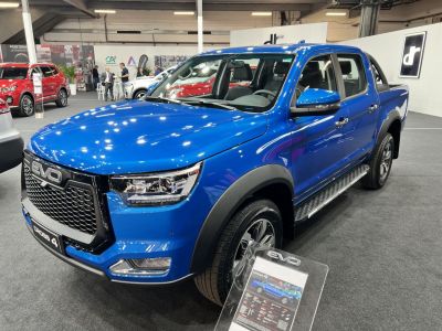 Blue pickup truck with bold front grille and LED headlights