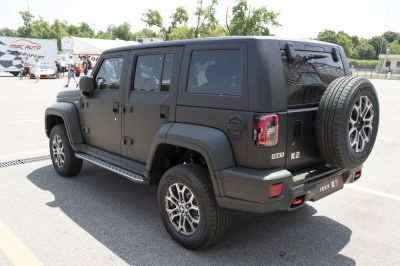 Matte black SUV rear side with spare wheel and distinctive tail lights