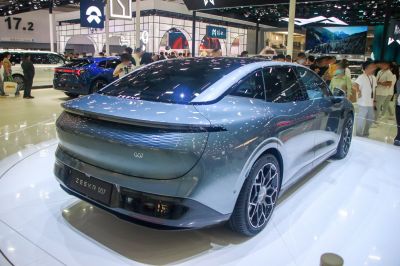 Sleek electric sedan rear with continuous LED tail light bar and aerodynamic design.