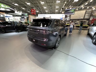 Rear view of a modern electric SUV with sleek tail lights and smooth contours