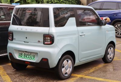 Rear view of compact microcar with square taillights and smooth body contours