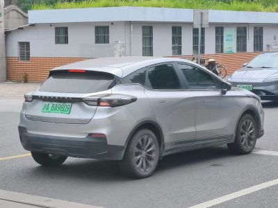 Silver hatchback rear side with sleek tail lights and tinted windows