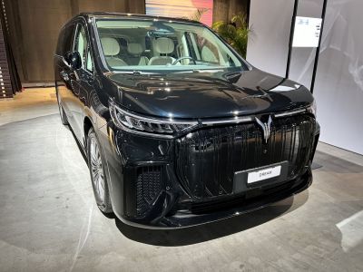 Sleek front view with detailed lighting and grille design