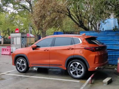 Bright orange SUV side profile with alloy wheels and tinted windows