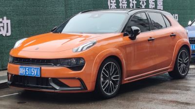 Orange hatchback with aerodynamic design and modern wheel rims