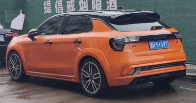 Orange hatchback with quad exhaust and black roof