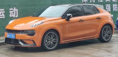 Orange and black two-tone hatchback with sleek headlights and sporty alloy wheels
