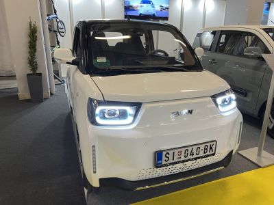 Compact electric vehicle with LED headlights and two-tone white and black design