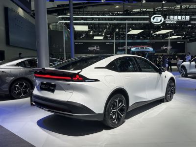 White electric sedan rear with LED light bar and sleek design