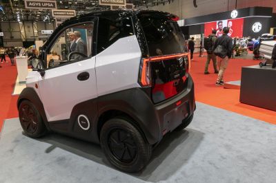 Compact electric microcar with distinctive rear lighting and black-white aerodynamic panels