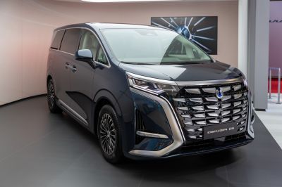 Bold front grille and sharp LED headlight design on a modern MPV.