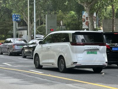 Rear view of sleek minivan with LED taillight strip and aerodynamic design