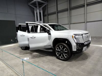 Electric crew cab pickup with LED headlights and open doors
