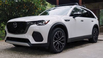 Front side view of an SUV with black grille and alloy wheels