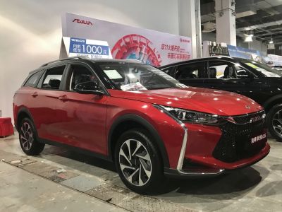 Red SUV with modern grille and sleek headlights from front-side angle