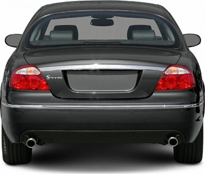 Rear view with tail lights, chrome trim, dual exhaust pipes.
