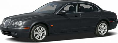 Luxury sedan with rounded quad headlights and chrome grille
