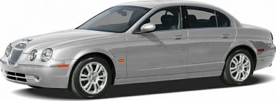 Silver four-door sedan with classic front grille and sleek profile