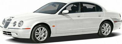 White luxury sedan with quad round headlights and multi-spoke wheels