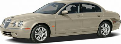 Front side view of a beige luxury sedan with distinctive grille and alloy wheels