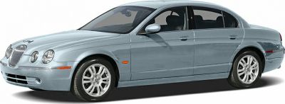 Side profile of a luxury sedan with classic design and alloy wheels.