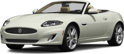 Front side view of white luxury convertible with headlights and alloy wheels