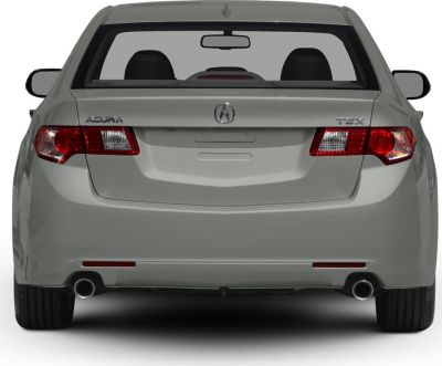 Rear view showing tail lights, trunk, and dual exhaust pipes.