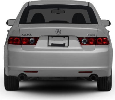 Rear view with dual exhaust tips and distinctive round-style tail lights