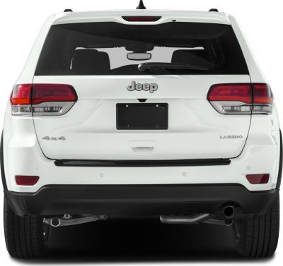 Rear view of white SUV featuring tail lights, license area, and rear badging