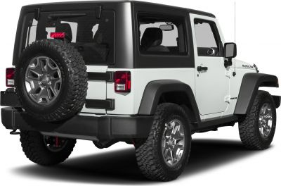 Rear side view featuring off-road tires and mounted spare wheel.