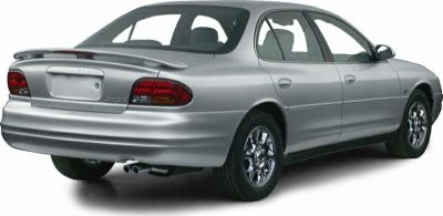 Rear view of mid-size sedan with taillights and chrome wheels