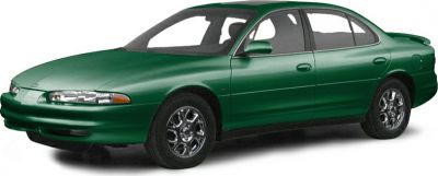 Green four-door sedan with alloy wheels in a front side view.