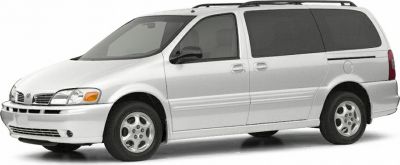 Side view of white minivan with sliding door and roof rack